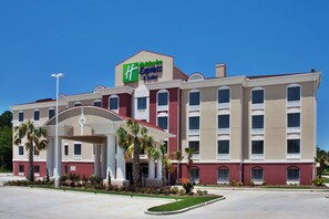 A Holiday Inn Express & Suites building with a central entrance, multiple windows, and a parking lot. - Holiday Inn Express Hotel & Suites AMITE by IHG (Amite)