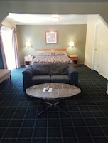 King Suite with Spa Bath, Nonsmoking | Living room | 40-inch LED TV with cable channels, TV