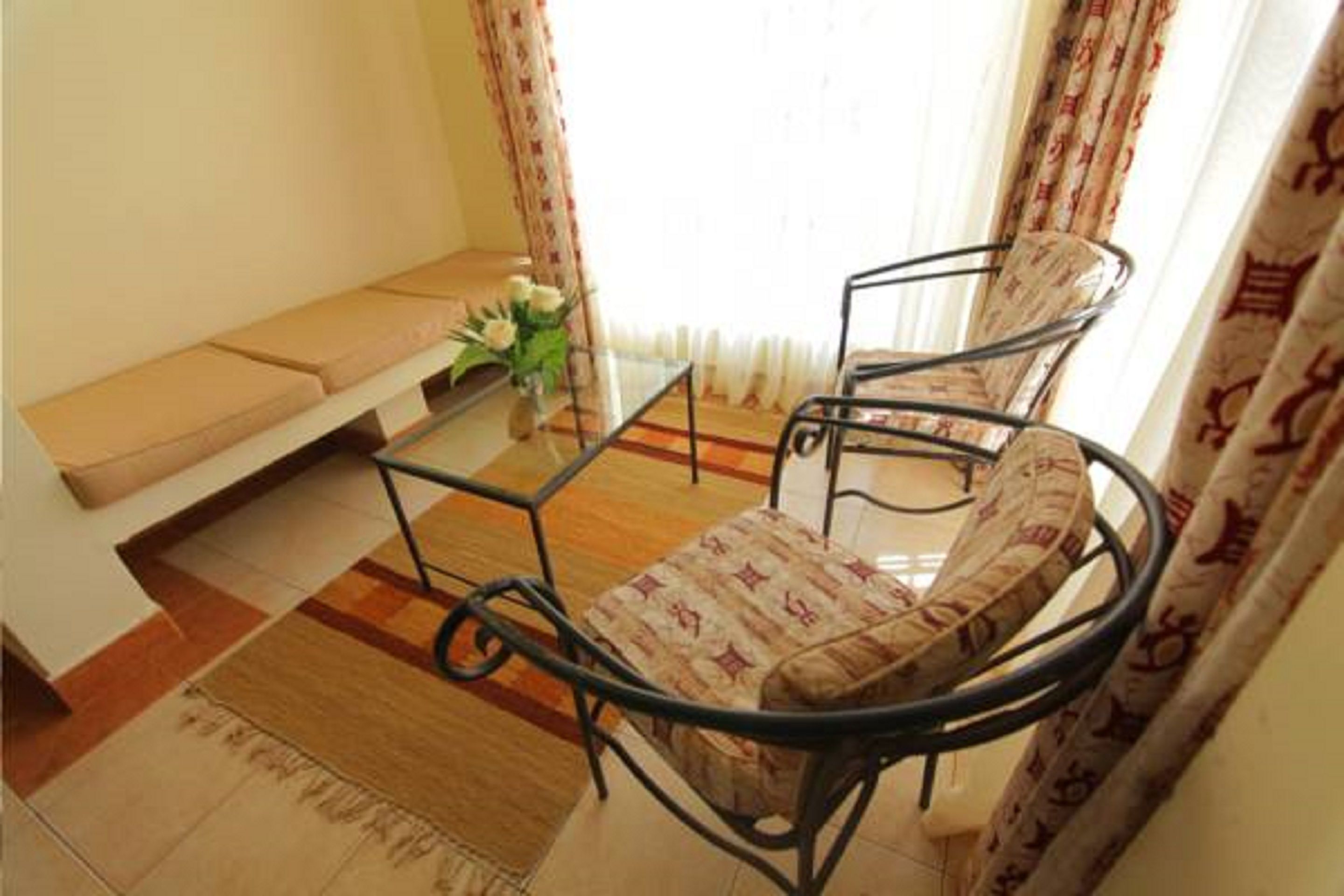 A living room with a sofa, a coffee table, and two chairs.