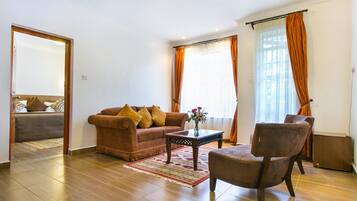 Standard Double Room | Living room | 48-inch flat-screen TV with digital channels, TV