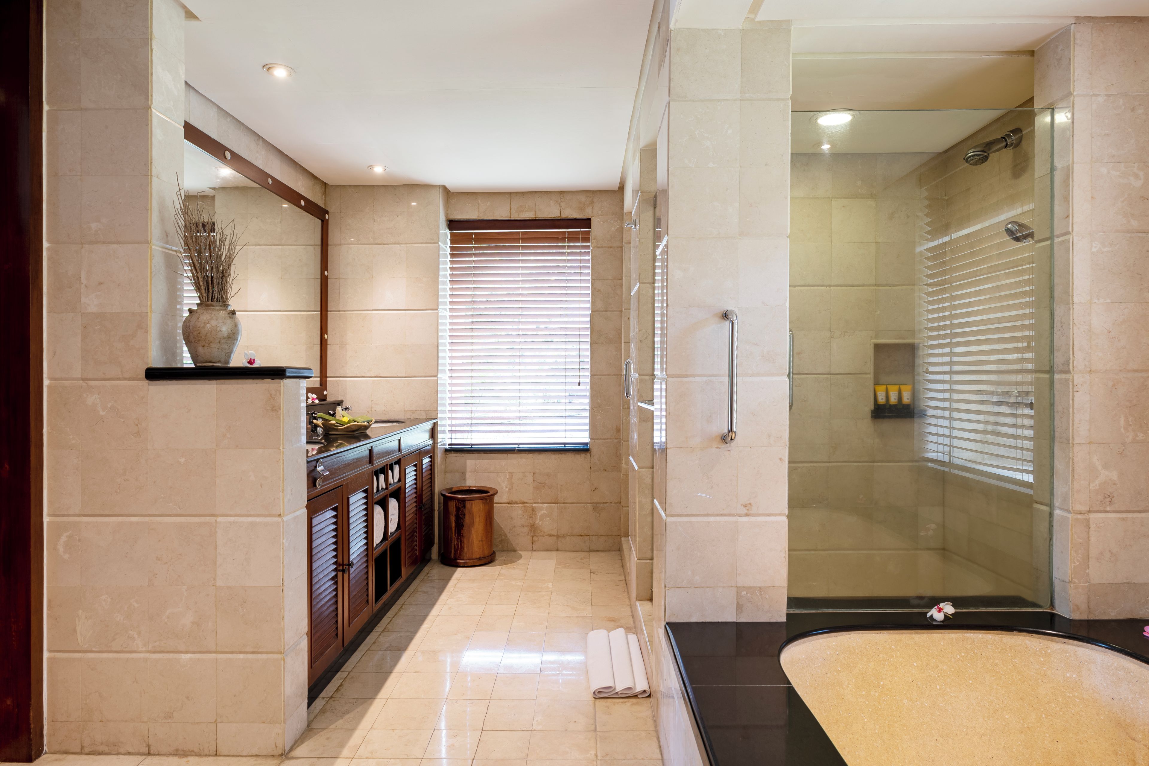 Een moderne badkamer met een douchecabine van glas, een wastafel met spiegel en een toilet.