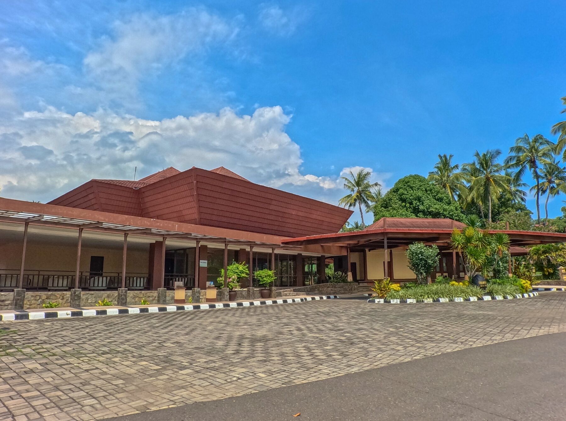 A building with a red roof and a covered walkway.