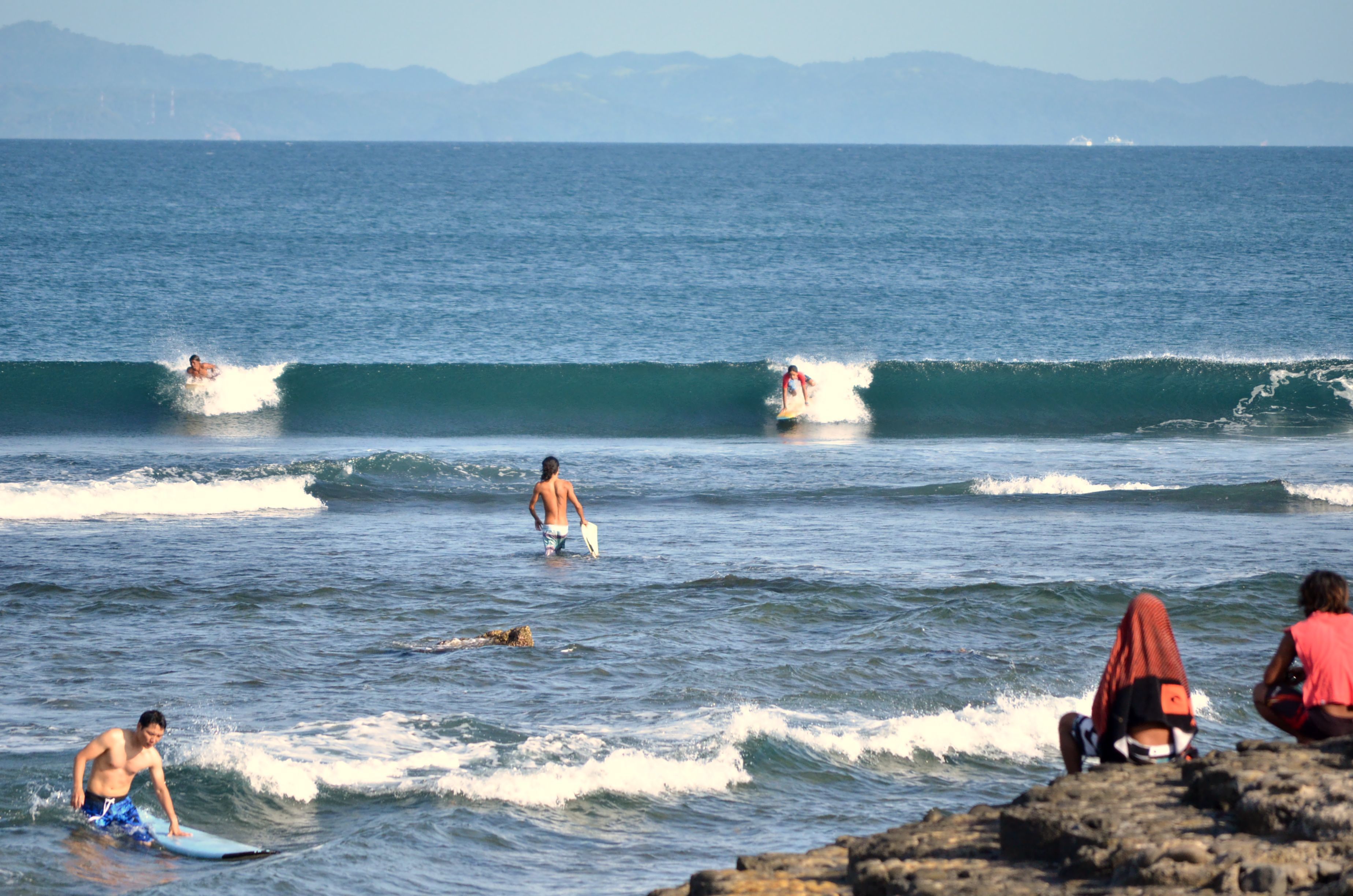 A beach scene with surfers and waves.