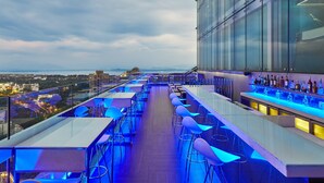 A rooftop bar with a view of the city and mountains, featuring modern bar stools and a glass railing. - The Westin Shenzhen Nanshan (Shenzhen)