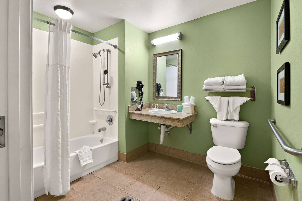 laptop workspace, blackout curtains, iron/ironing board