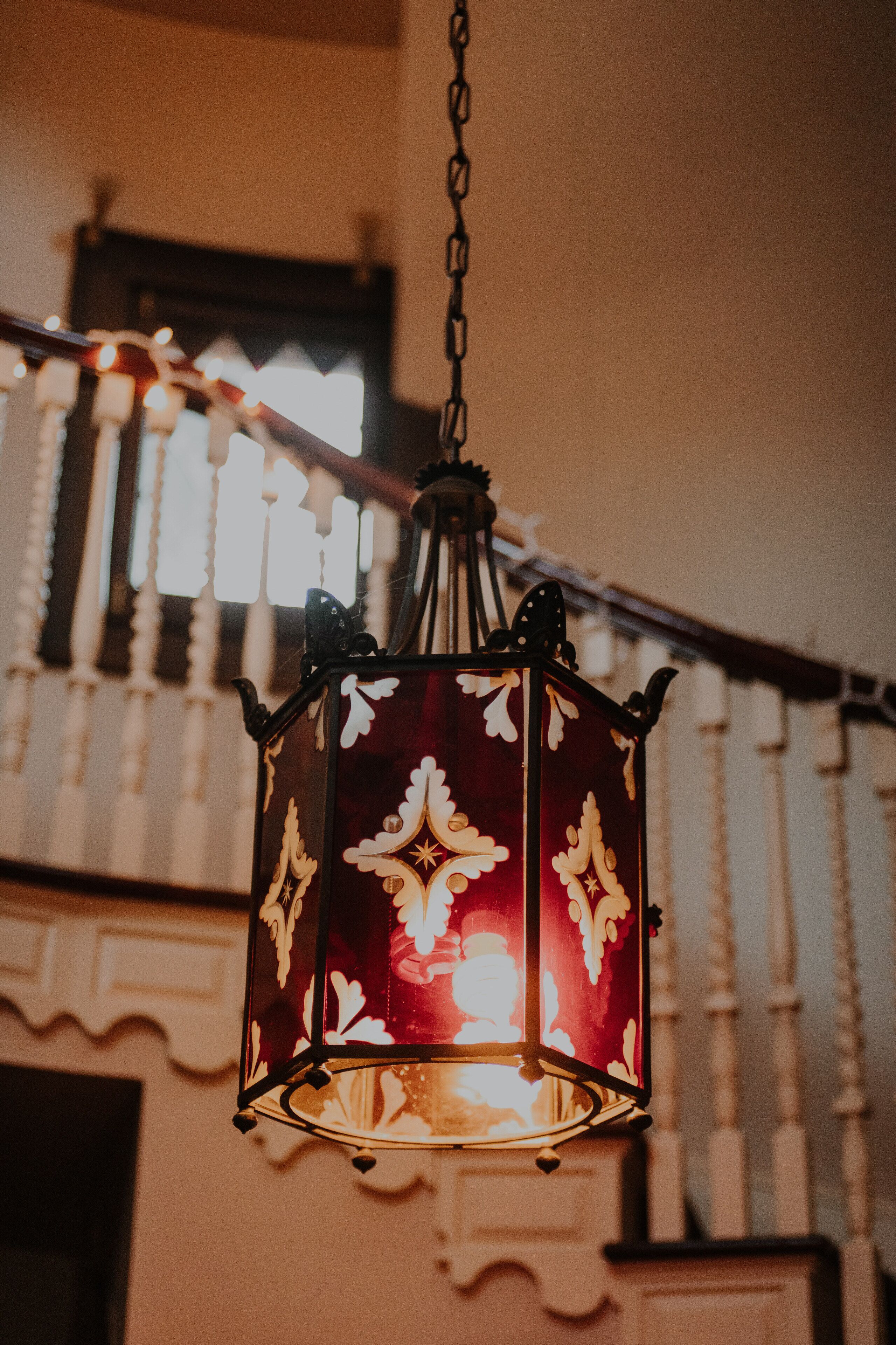 A hanging lantern with intricate patterns and a warm light source.
