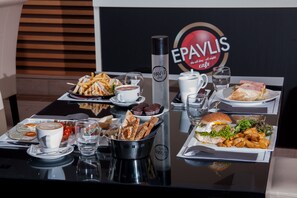 A table set with various breakfast items including eggs, toast, and coffee.