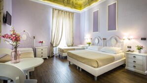 A hotel room with two beds, a desk, a chair, a vanity with a mirror, and a window with curtains. - Hotel Ferrucci Firenze (Florence)