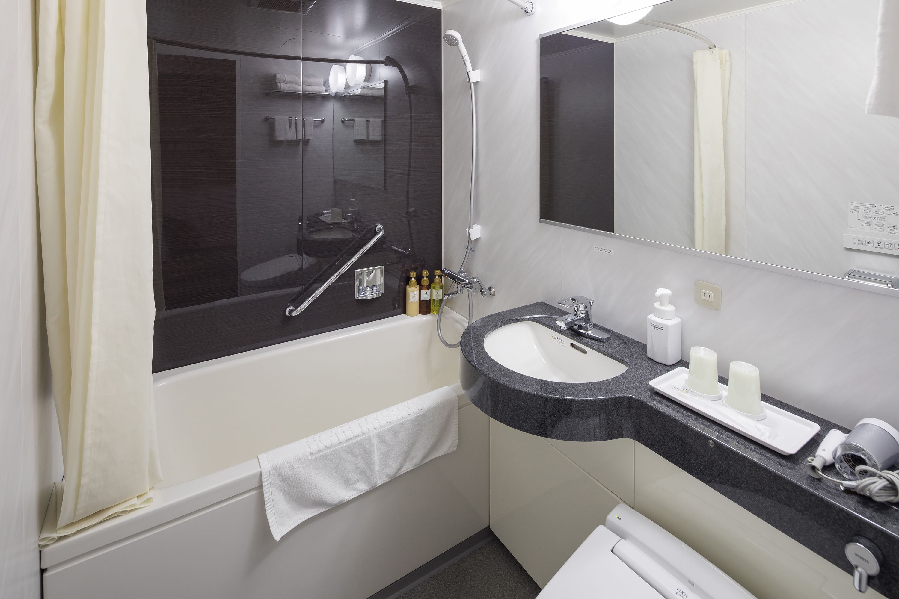 combined shower/bathtub, free toiletries, hair dryer, slippers