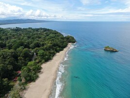 On the beach, white sand, beach towels, beach bar