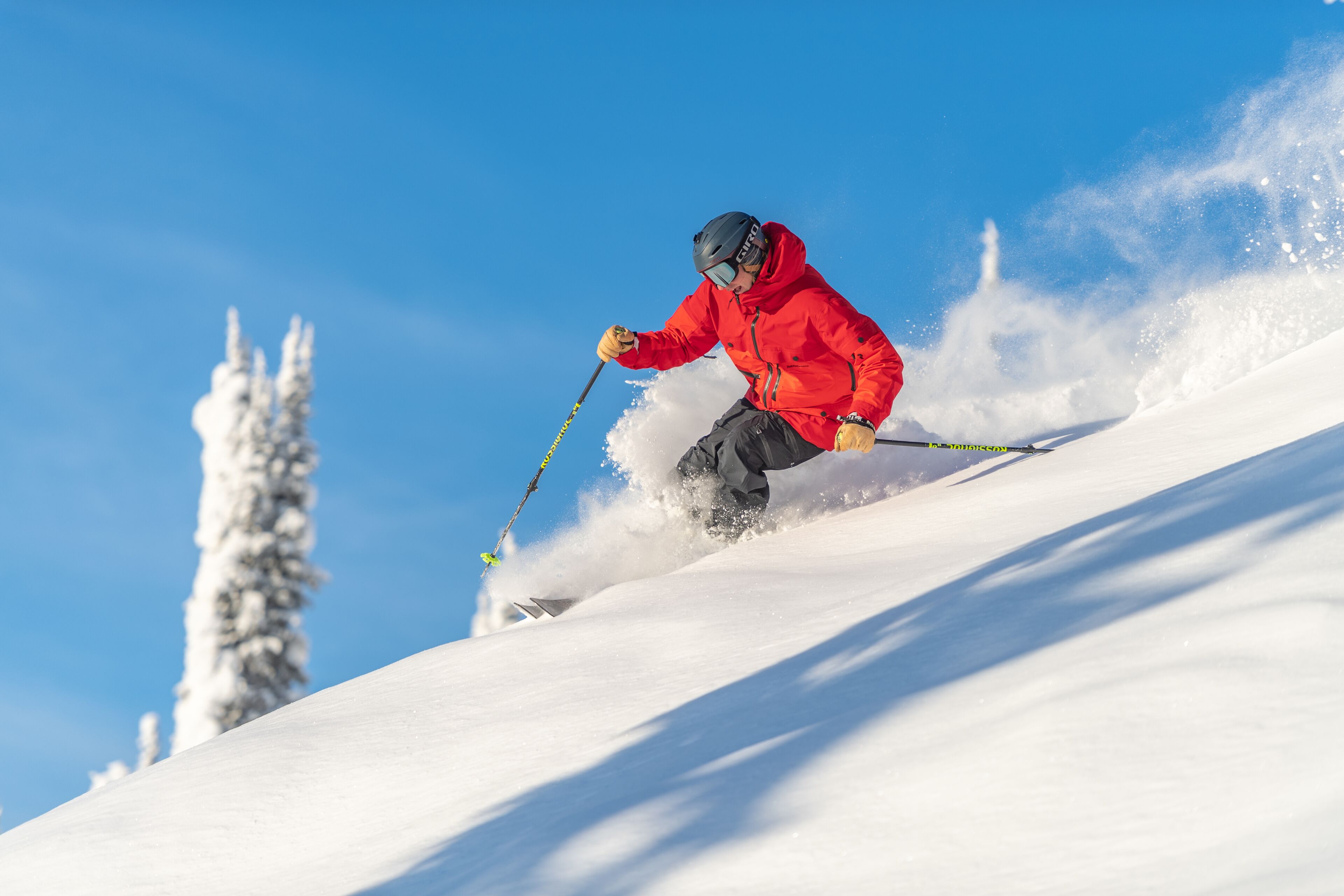 A person skiing down a snowy slope.
