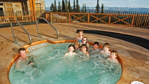 A group of people in a hot tub with a view of mountains in the background. - Sundance Resort (Beaverdell)