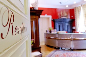 Experience the traditional charm of this resort room, featuring a wooden cabinet and a patterned rug.