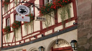A traditional half-timbered building with a sign indicating it is a hotel. - Hotel Elch (Nuremberg)