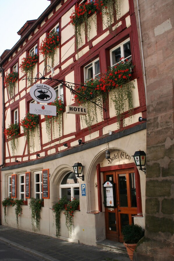 A traditional half-timbered building with a sign indicating it is a hotel.