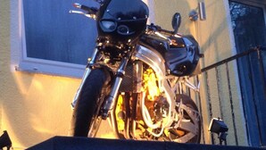 A motorcycle parked in front of a building with the sign "Holl". - Hotel Holl (Cochem)