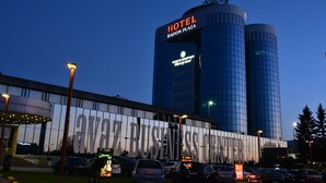 A hotel with a modern glass facade, a large sign reading "HOTEL RADON PLAZA," and a visible entrance with a covered area. - Radon Plaza (Sarajevo)
