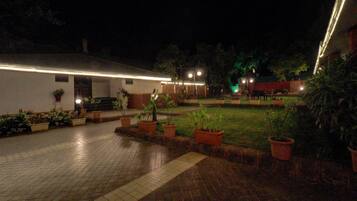 Experience a serene courtyard with potted plants and a secure, well-lit atmosphere.