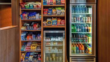 A well-stocked snack and beverage refrigerator with various brands and types of snacks and drinks.