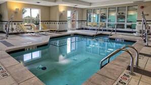 A swimming pool with lounge chairs and a lifeguard stand. - Fairfield Inn & Suites Oklahoma City Airport (Oklahoma City)
