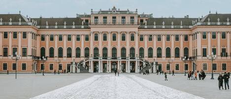 A large, symmetrical building with a central staircase and multiple windows.