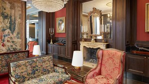 A luxurious room with a grand chandelier, ornate furniture, and a large mirror reflecting the room's decor. - Living Hotel an der Oper (Vienna)