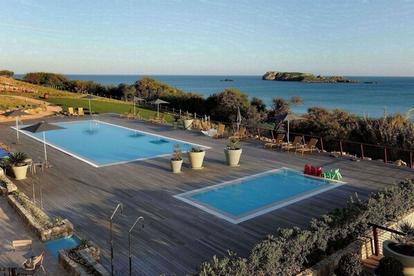 Indoor pool, 3 outdoor pools, open 8 AM to 8 PM, pool umbrellas