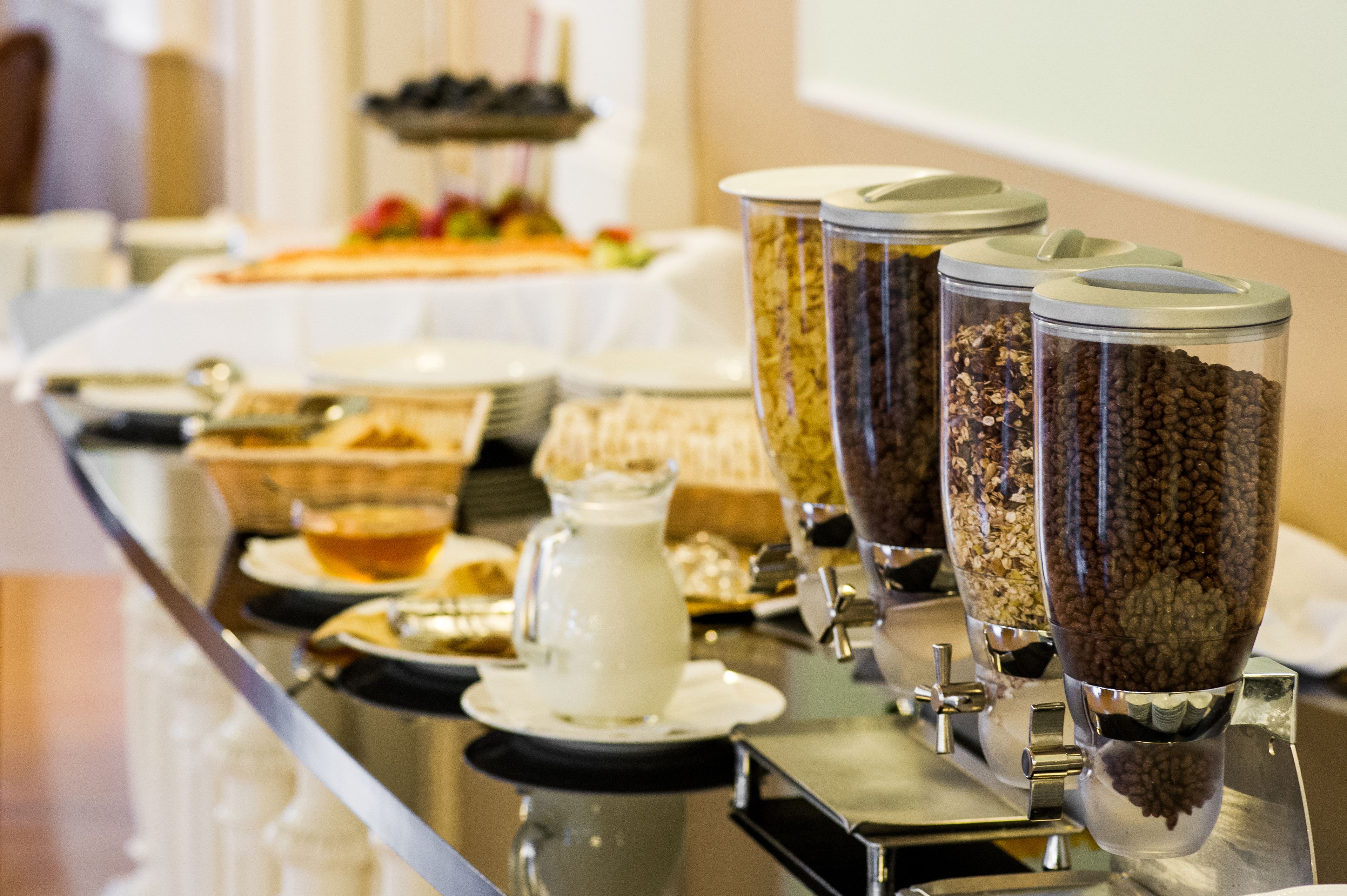 A buffet table with various food items and containers.