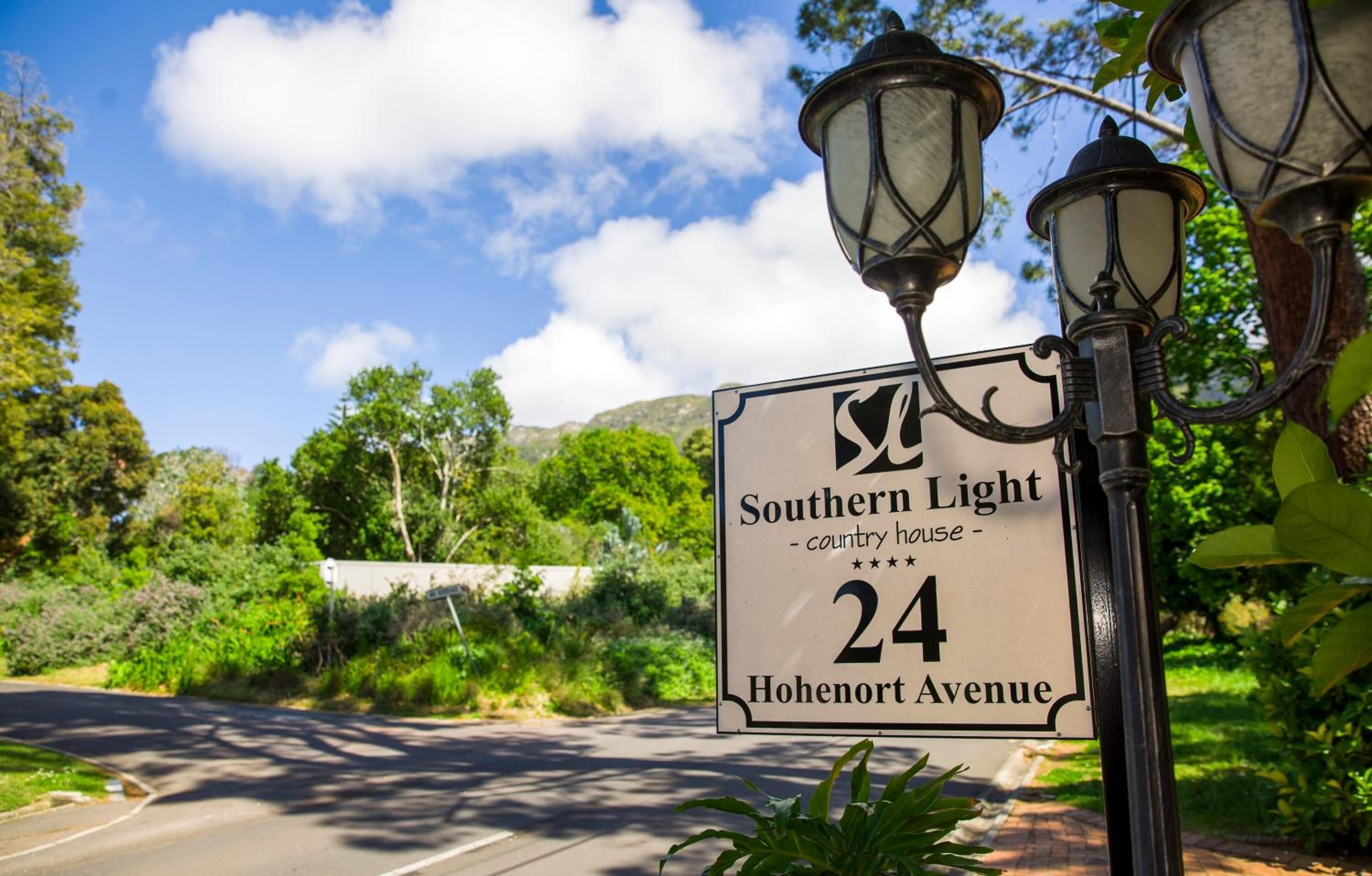 A street sign for 'Southern Light Country House' at 24 Hohenort Avenue.