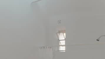 A bathroom with a toilet, bidet, bathtub, and sink.