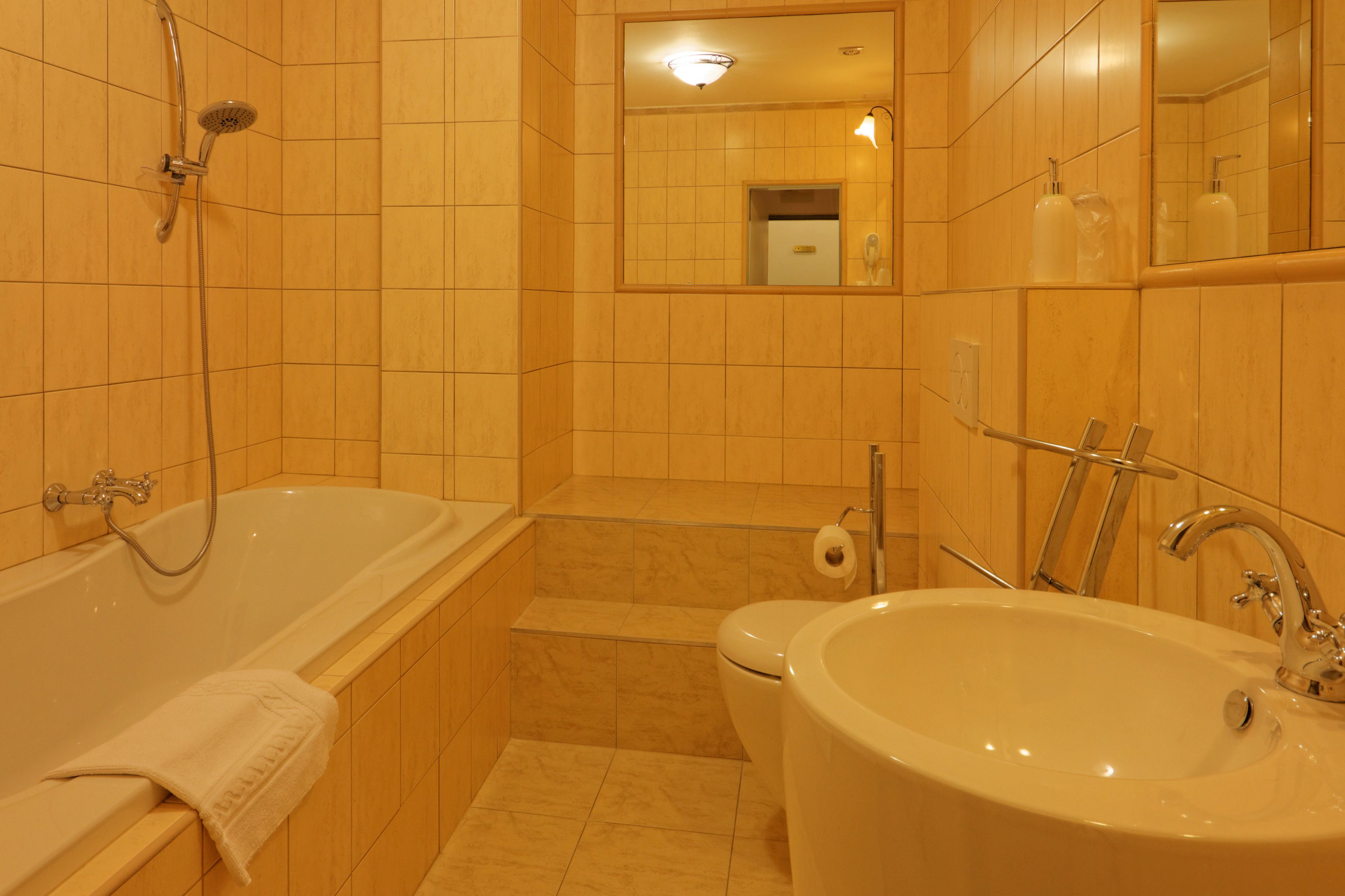 A bathroom with a bathtub, a sink, and a toilet.