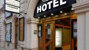 A hotel entrance with a sign indicating it is a hotel, a home cafe, and an exchange. - Enjoy Inn (Plzen)