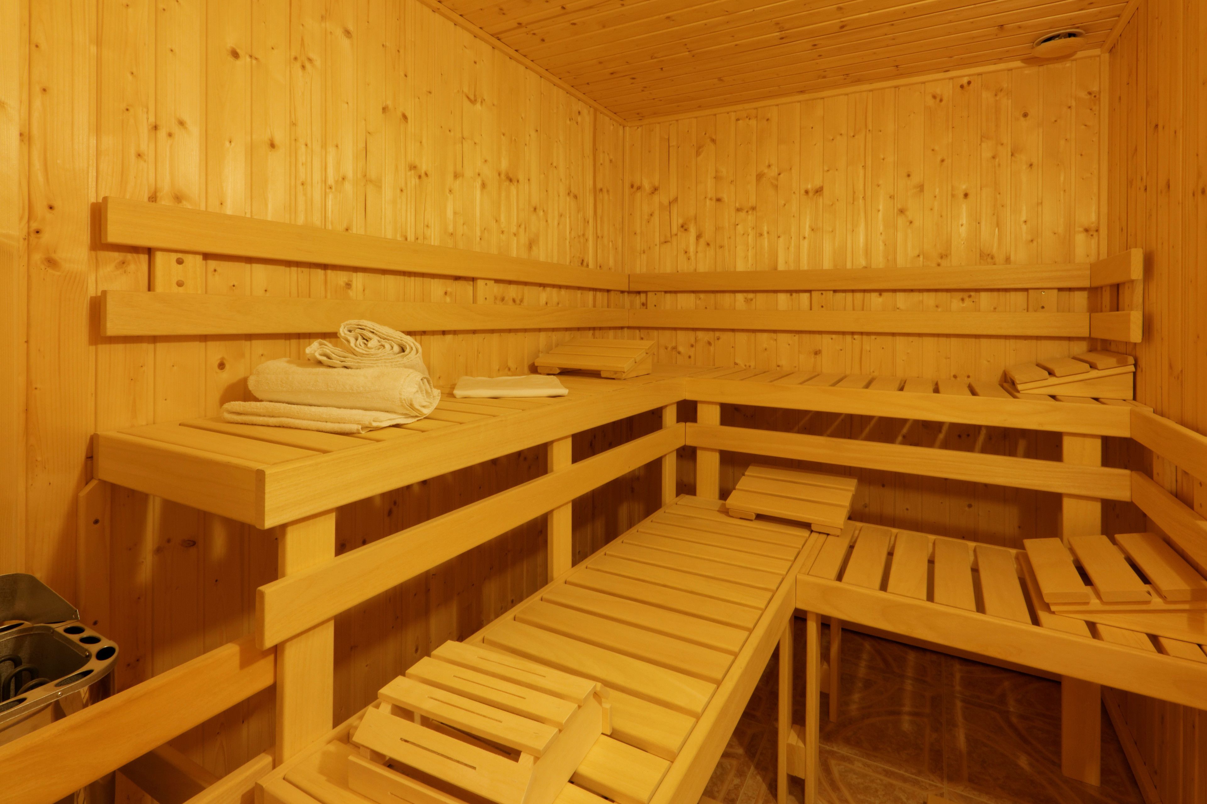 A wooden sauna with benches and a bench seat.