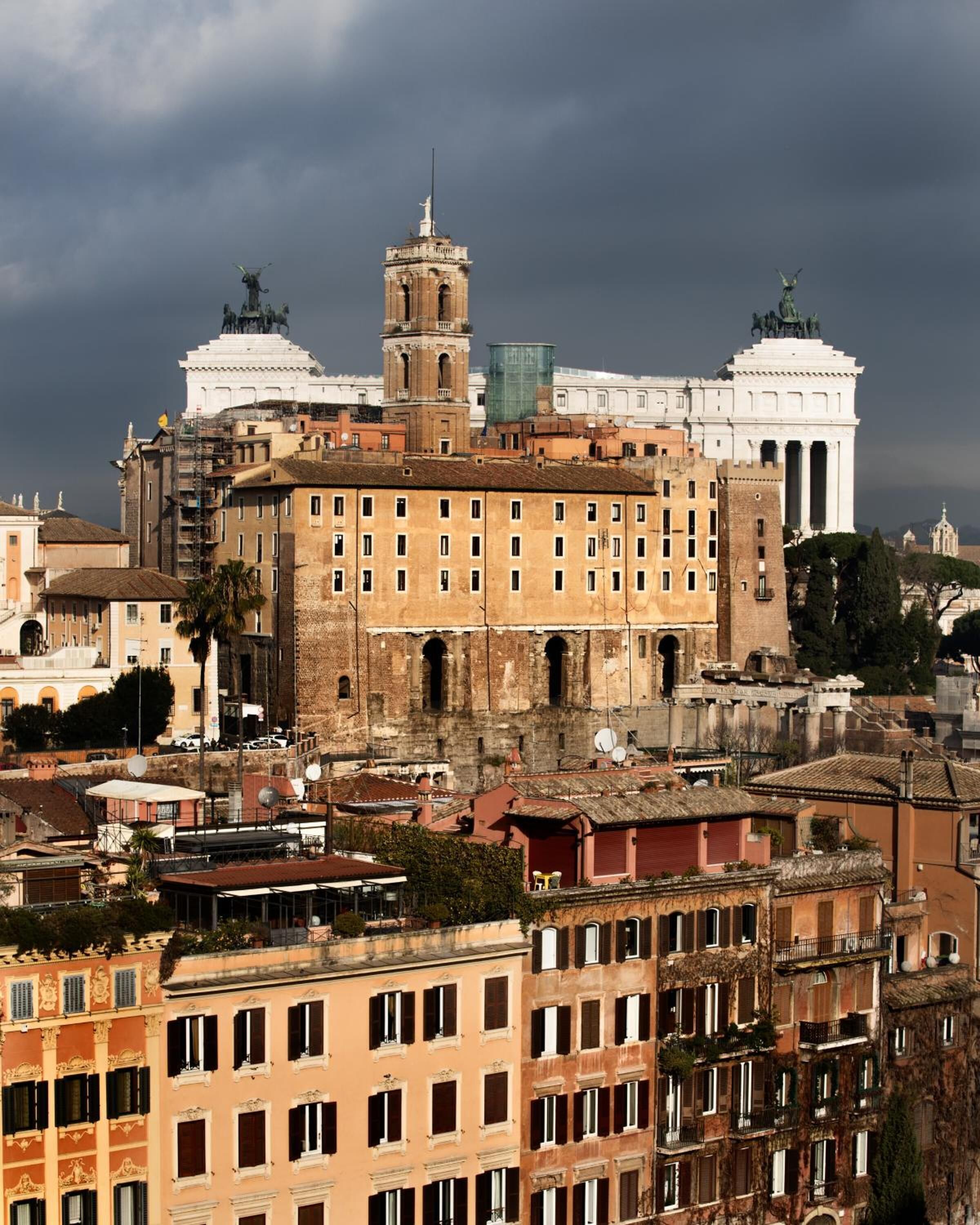 A historic building with a central tower, surrounded by other structures.