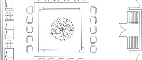 Un plano de planta que muestra una zona circular central rodeada de habitaciones rectangulares, probablemente el diseño de un hotel.