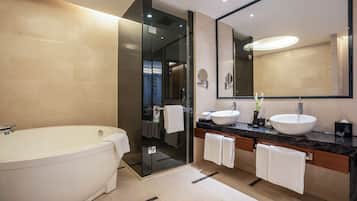 Deluxe Suite, 1 King Bed, Balcony | Bathroom | Eco-friendly toiletries, bathrobes, slippers, towels