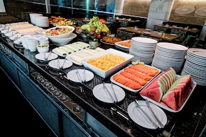 Enjoy a diverse selection of sweet and savory options at our buffet, featuring a variety of fruits, vegetables, and prepared dishes.