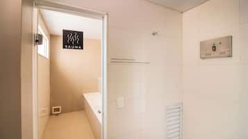 Um banheiro moderno com placa de sauna, painel de controle e piso ladrilhado.