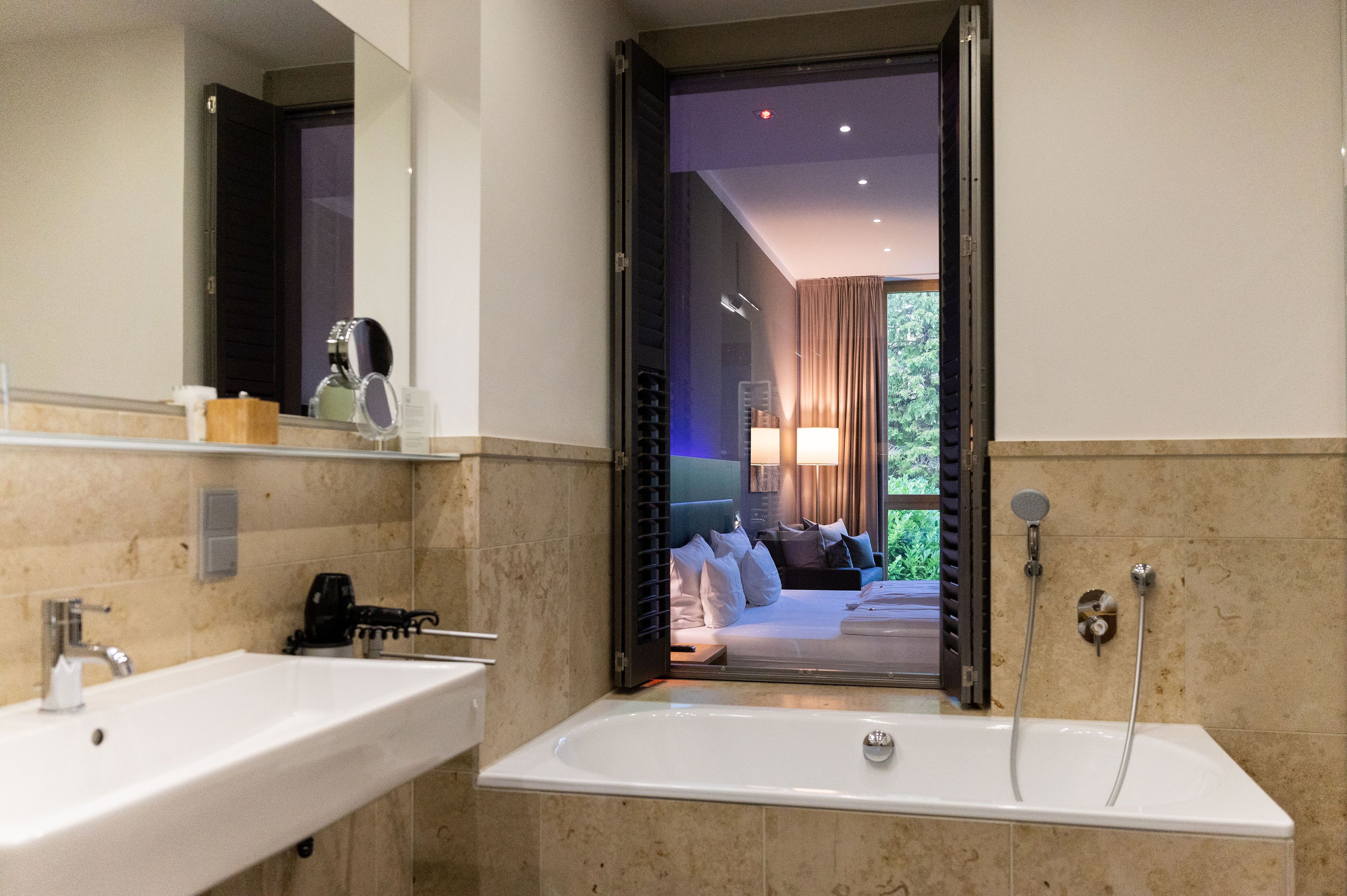 junior suite | bathroom | shower, free toiletries, hair dryer, towels