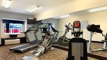 A gym with treadmills, elliptical machines, and a stationary bike.
