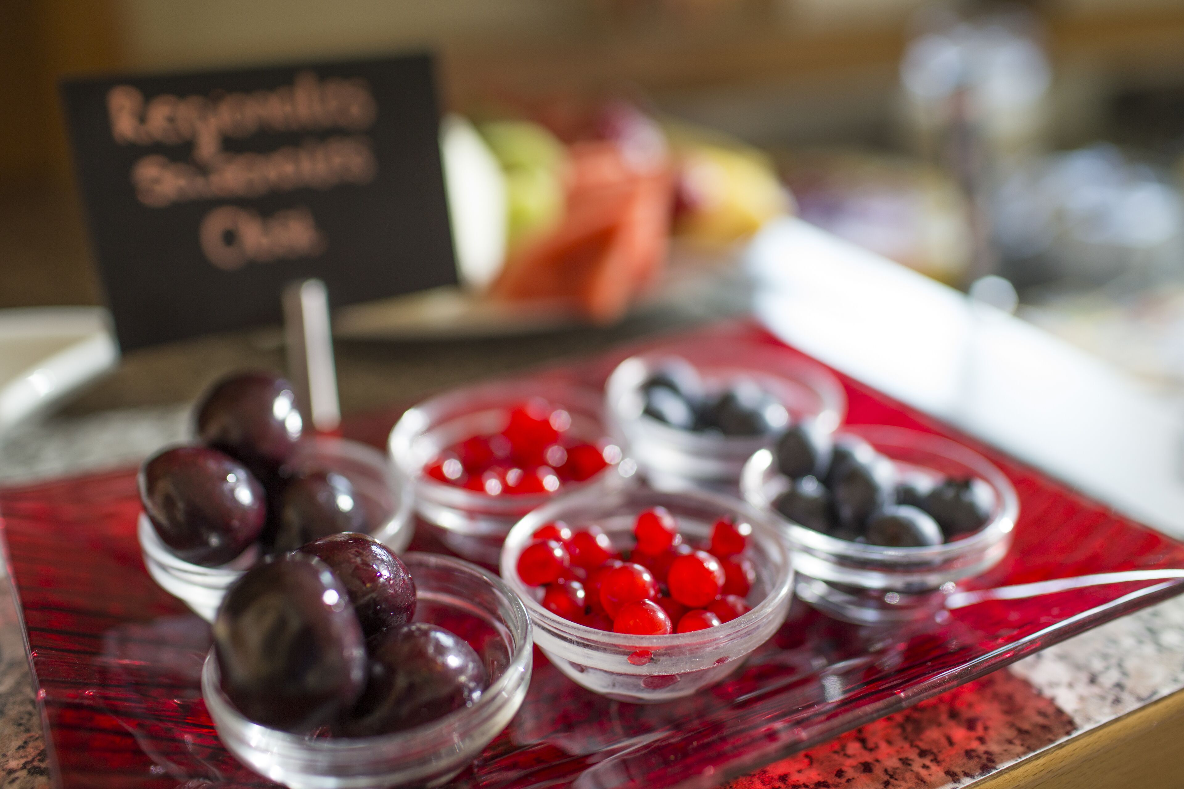 A dessert display with various fruits and a sign reading "Refreshing Summer Treats".