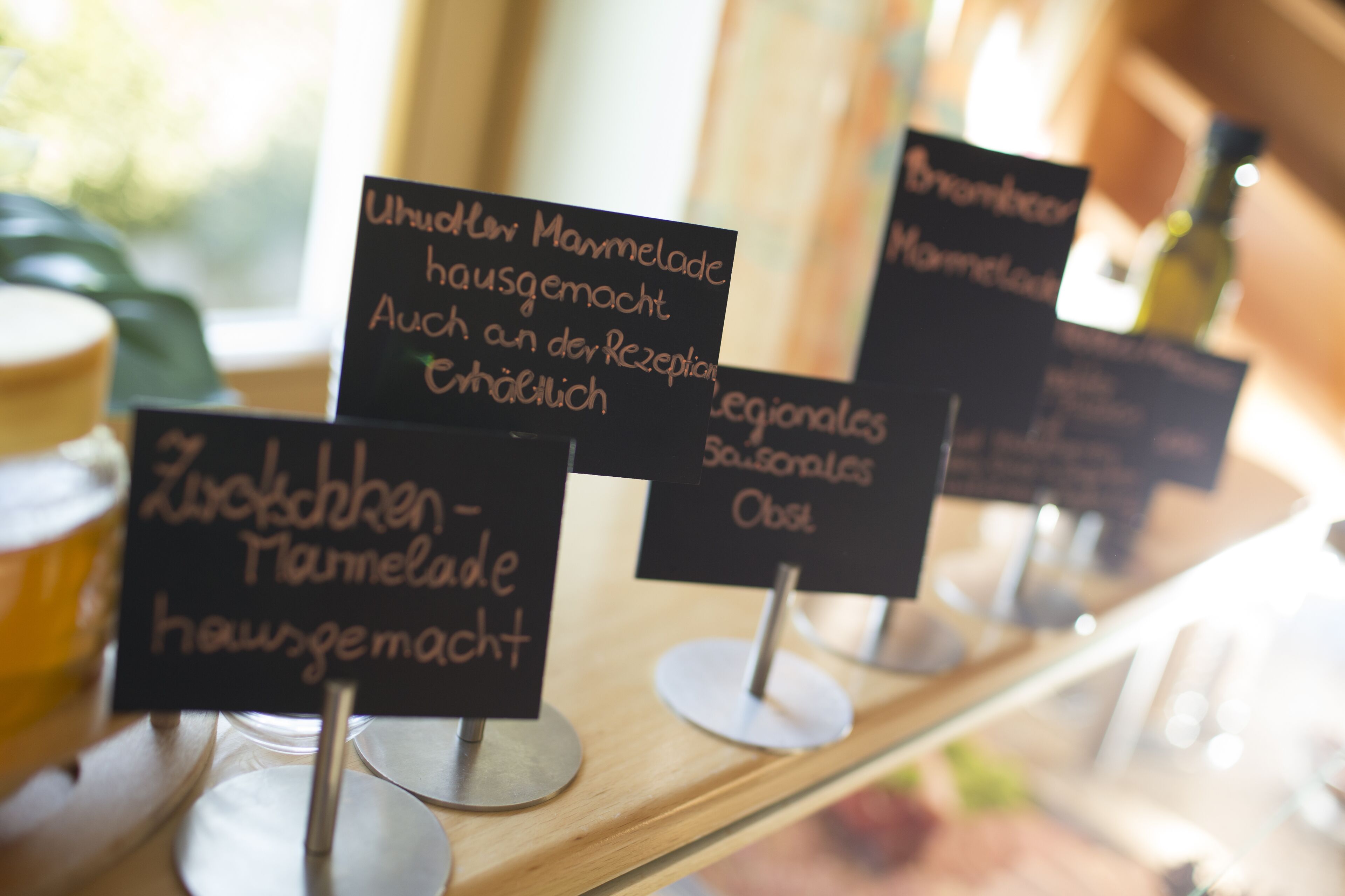 A menu board with various items listed in German, including 'Zuckerschaben - hausgemacht'.