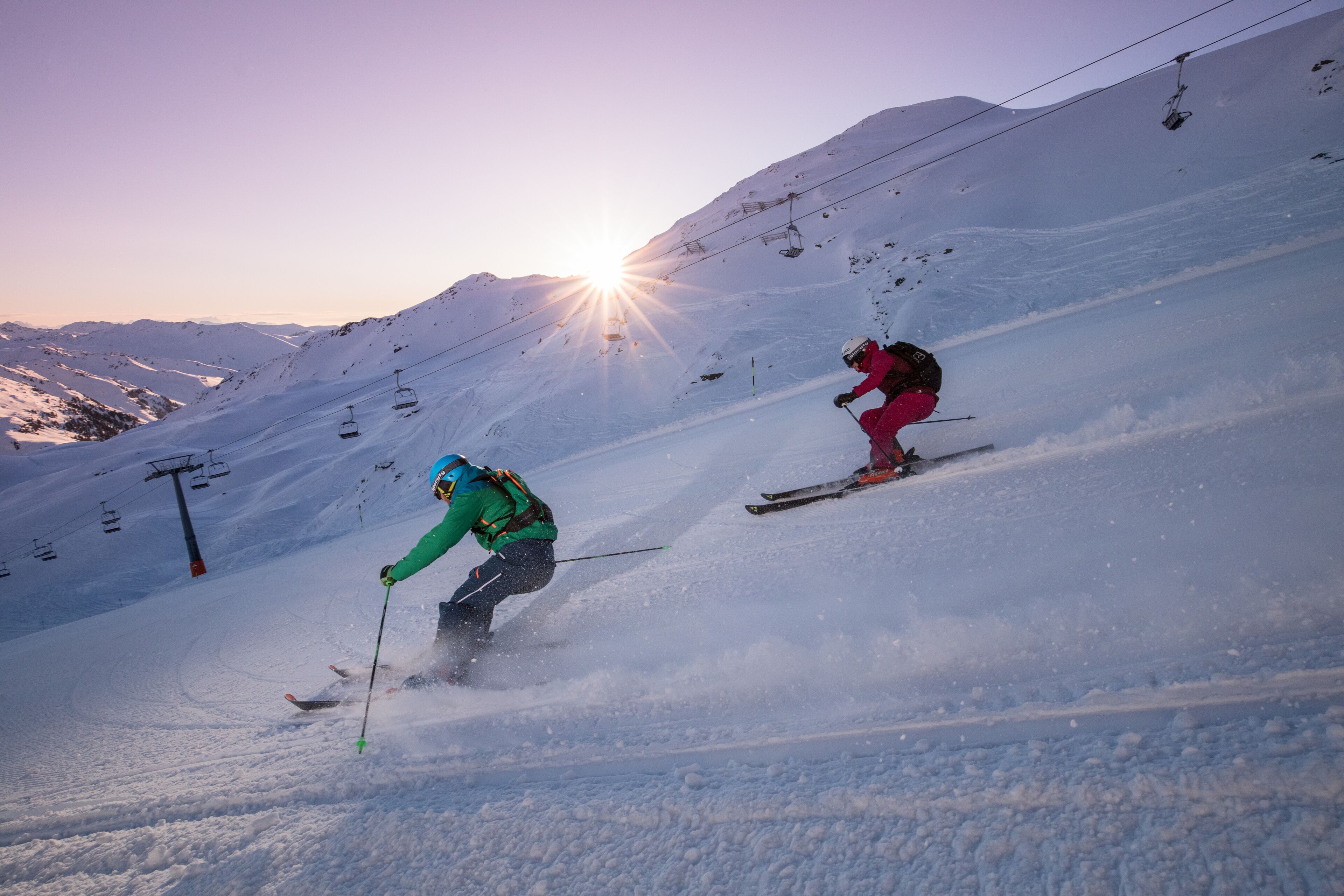 A ski slope with skiers and a ski lift.