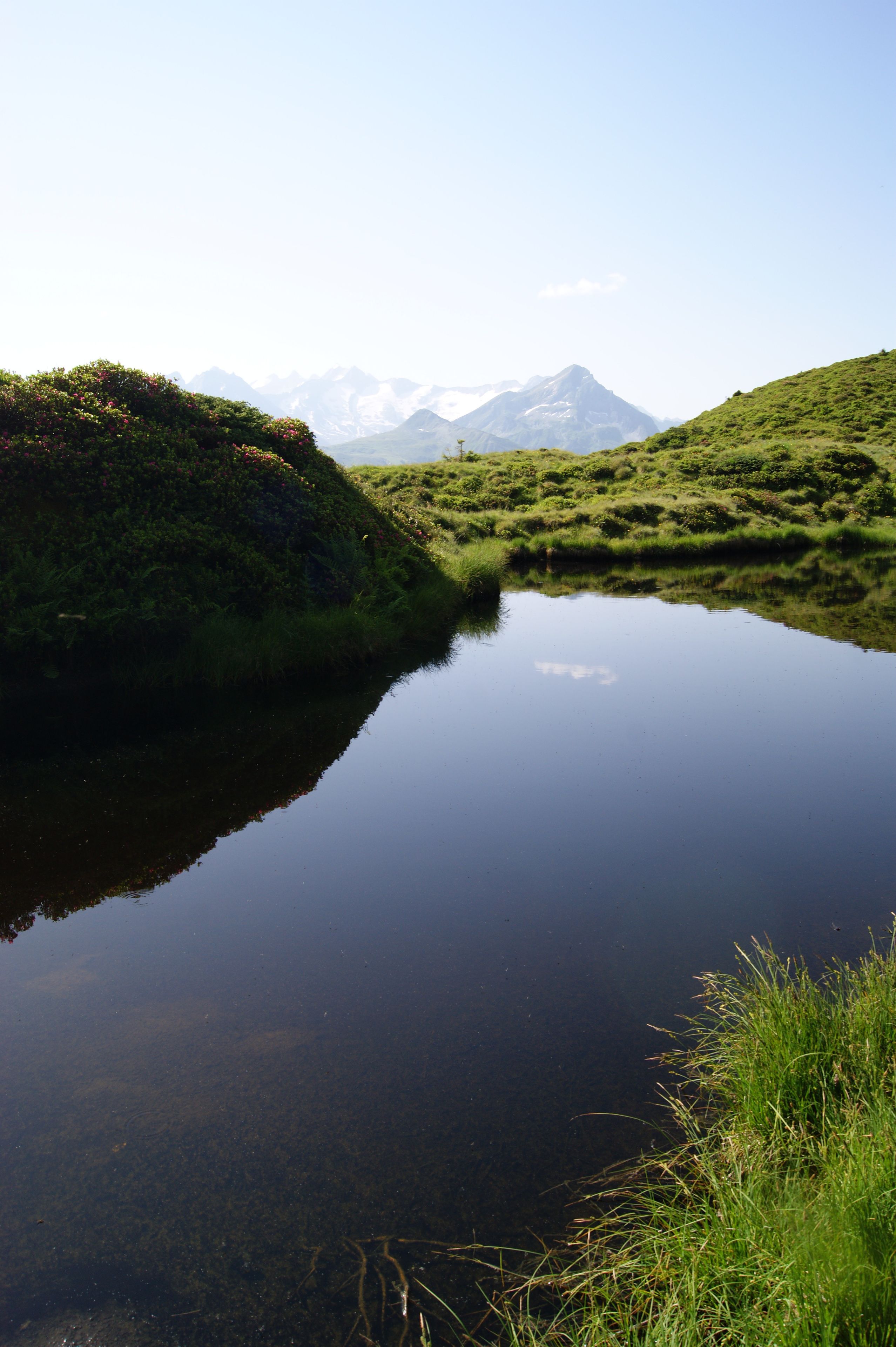 A calm lake reflecting a mountain range.