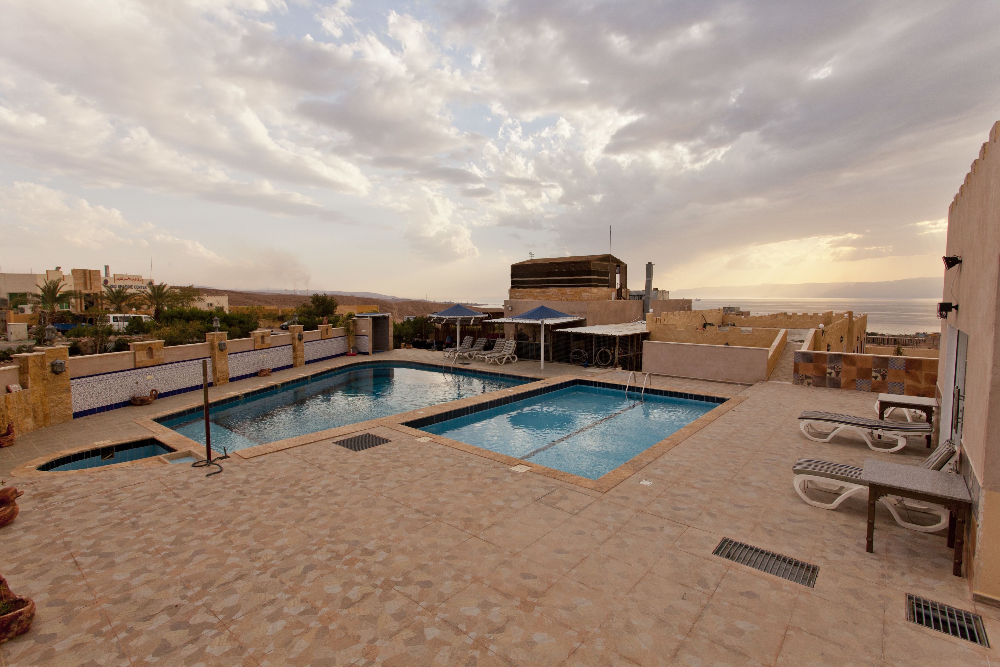 outdoor pool, pool umbrellas, pool loungers