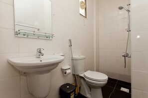 A bathroom with a sink, toilet, and shower.