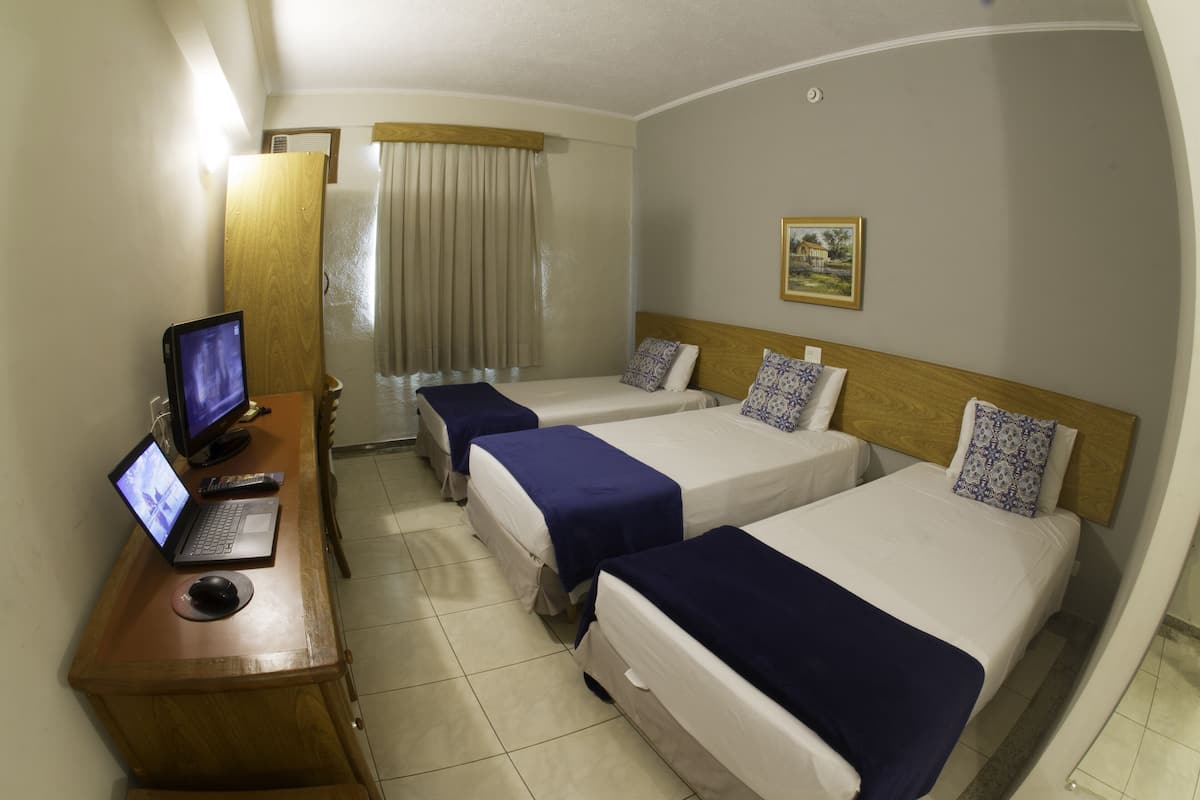 Standard Triple Room | Minibar, in-room safe, desk, laptop workspace