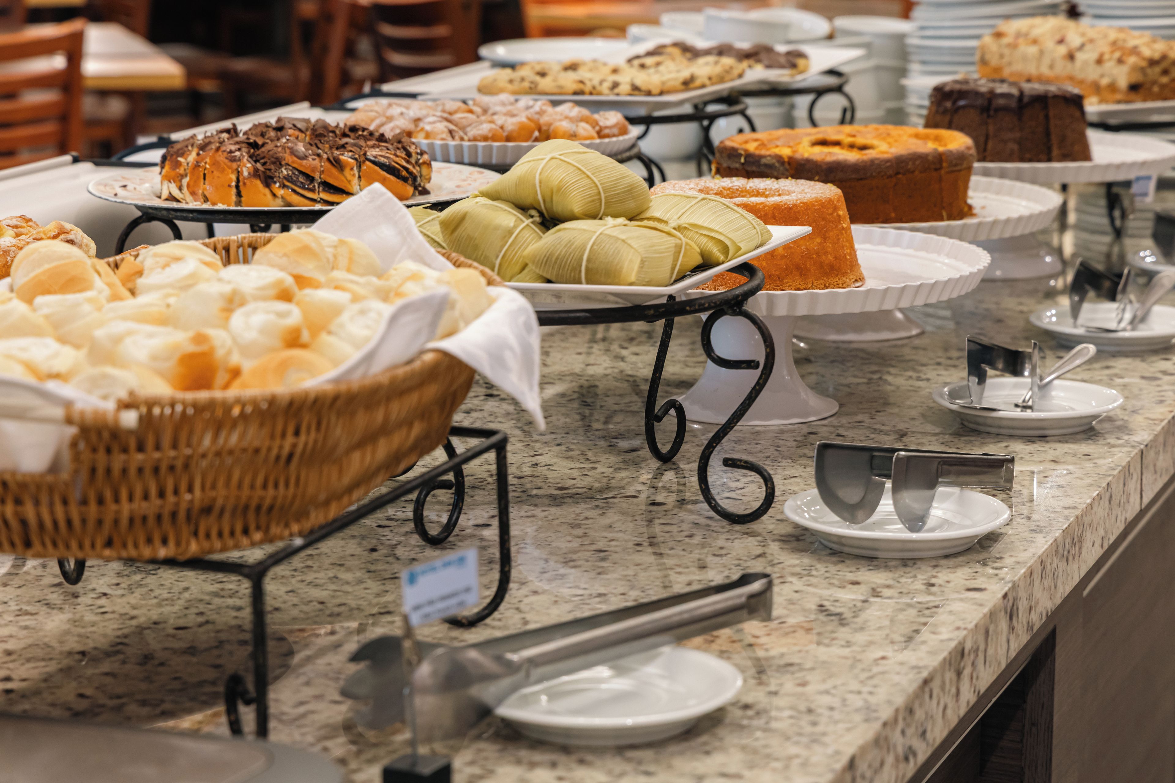 A buffet with various baked goods and pastries.