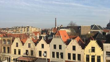 A row of traditional European buildings with distinct architectural styles, including a visible sign for 'Twee Wielers' and 'Olpenburger'.