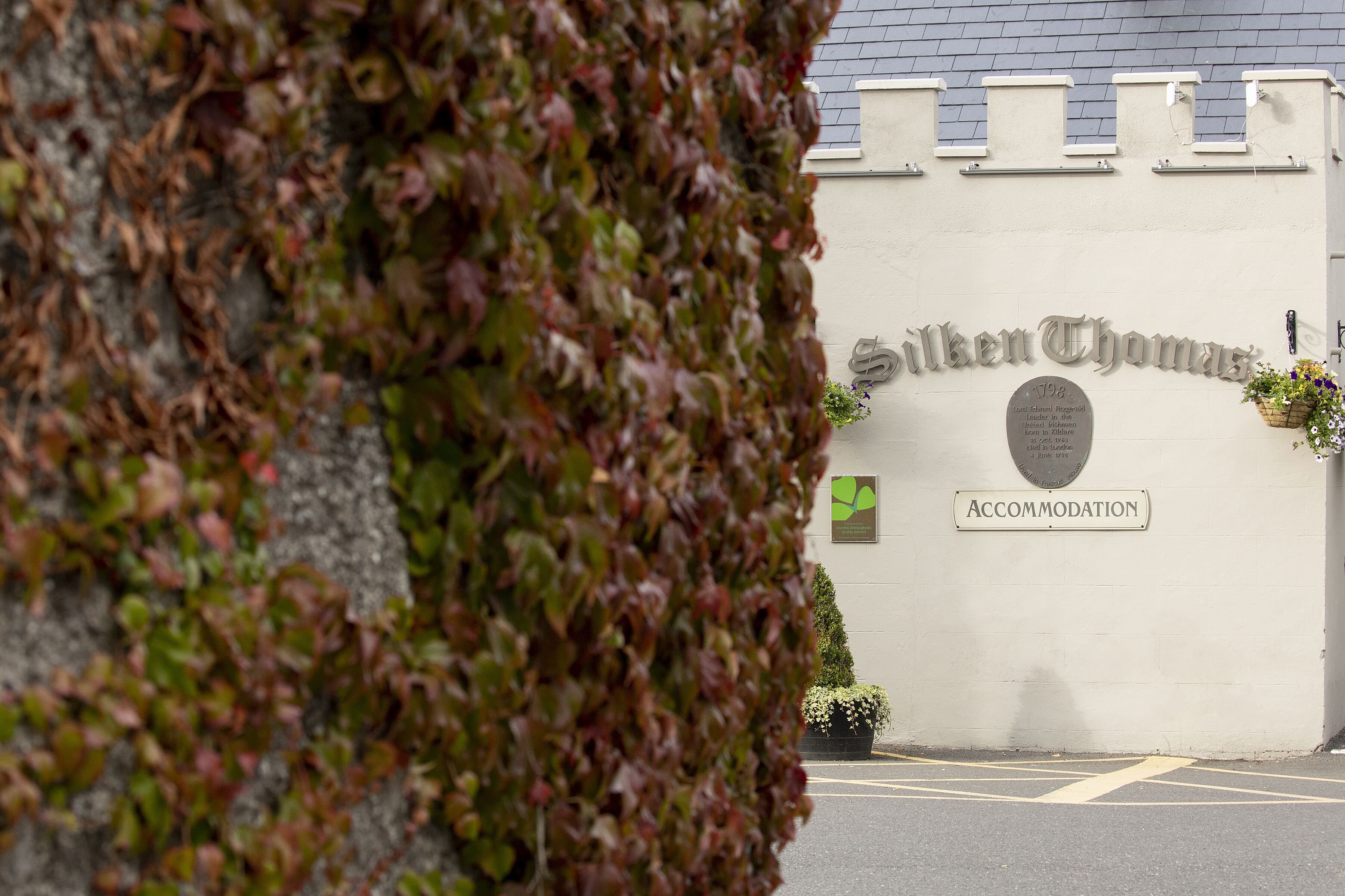 A building with a sign reading "Silken Thomas" and "Accommodation".